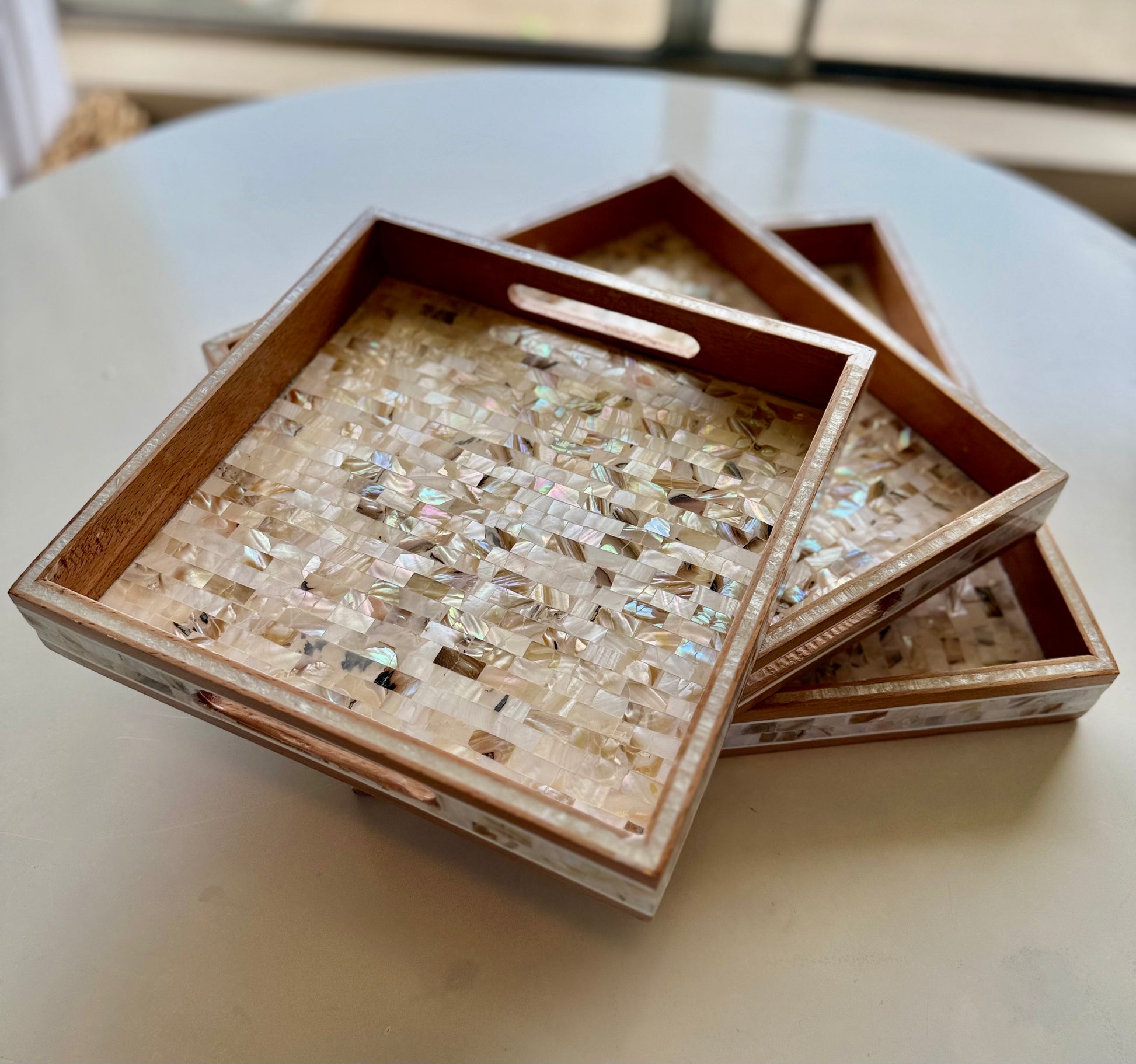 Decorative tray with mosaic design on a light surface